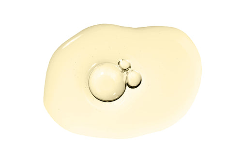 A splatter of oil with bubbles on a white background.