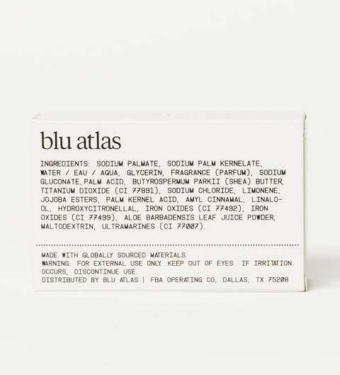 The back of a Blu Atlas Natural Exfoliating Bar Soap box showcases the ingredients list, highlighting nourishing Shea Butter and gentle Jojoba Beads for a smooth cleanse, along with essential warning information.