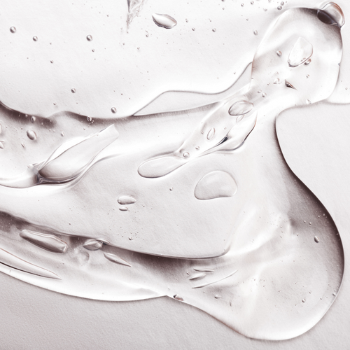 Clear gel with bubbles spread on a white surface.
