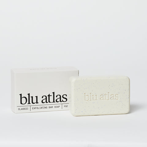 White bar of Exfoliating Blu Atlas bar soap next to packaging