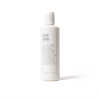 A white bottle labeled Hydrating Body Wash by Blu Atlas, featuring luxurious sandal and cedar scents enriched with hydrating ingredients and coconut-derived emollients, is set against a plain white background.