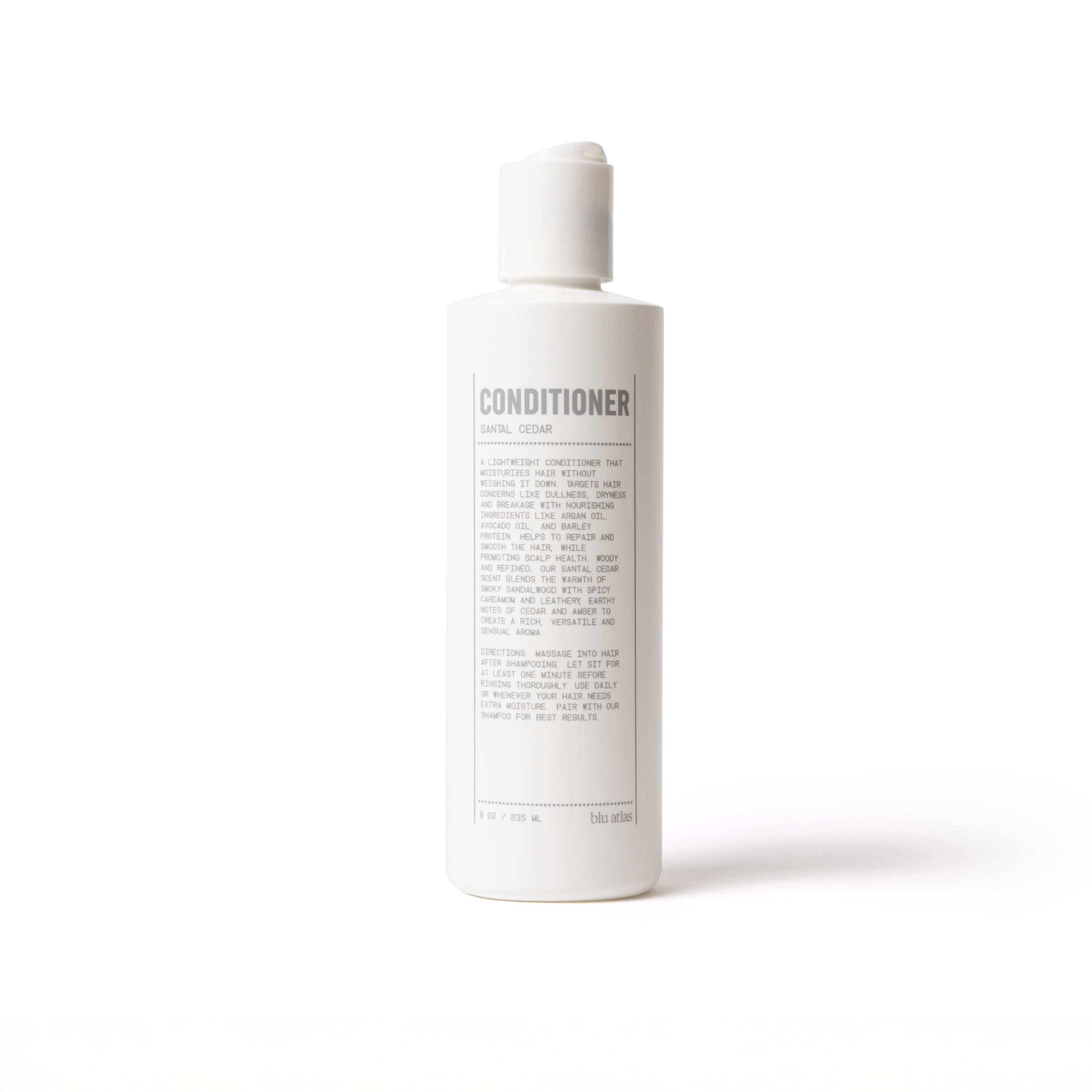A white bottle of lightweight Blu Atlas conditioner with a flip-top cap, labeled "Soothing and Smoothing Natural Conditioner" in bold text. The label includes additional descriptive details highlighting its nourishing ingredients designed to restore shine.