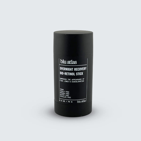 A black cylindrical Blu Atlas Bio-Retinol Stick stands upright on a plain light gray background.