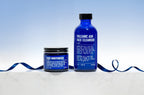 Blu Atlas Daily Face Essentials includes cleanser and moisturizer in sleek blue containers, set on a white surface with a blue ribbon and gradient background—ideal for your daily skincare routine.