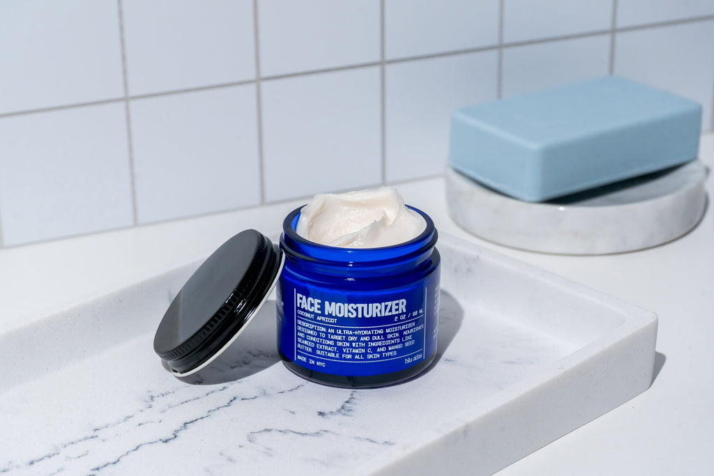 An open jar of Blu Atlas Face Essentials (Cleanser + Moisturizer) is shown.