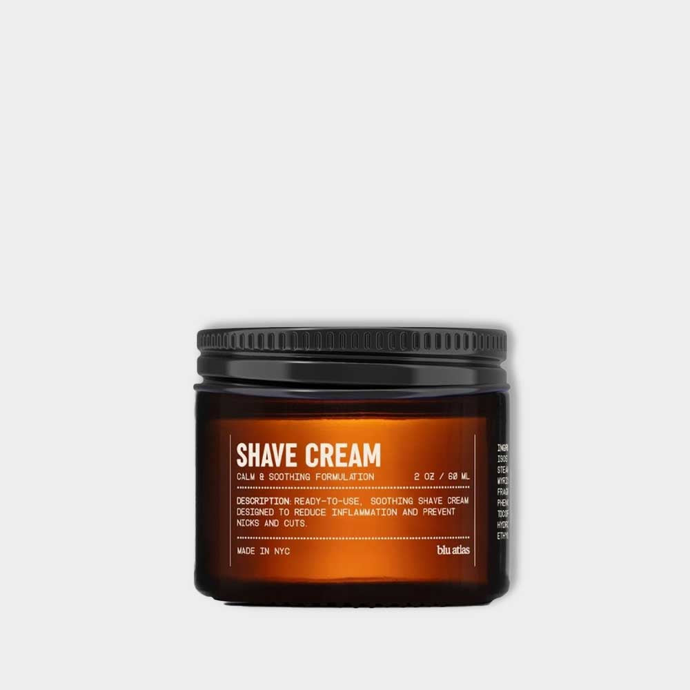 A brown jar of Blu Atlas Shave Cream with a black screw-on lid sits against a white background; made with natural ingredients, it soothes and hydrates skin.