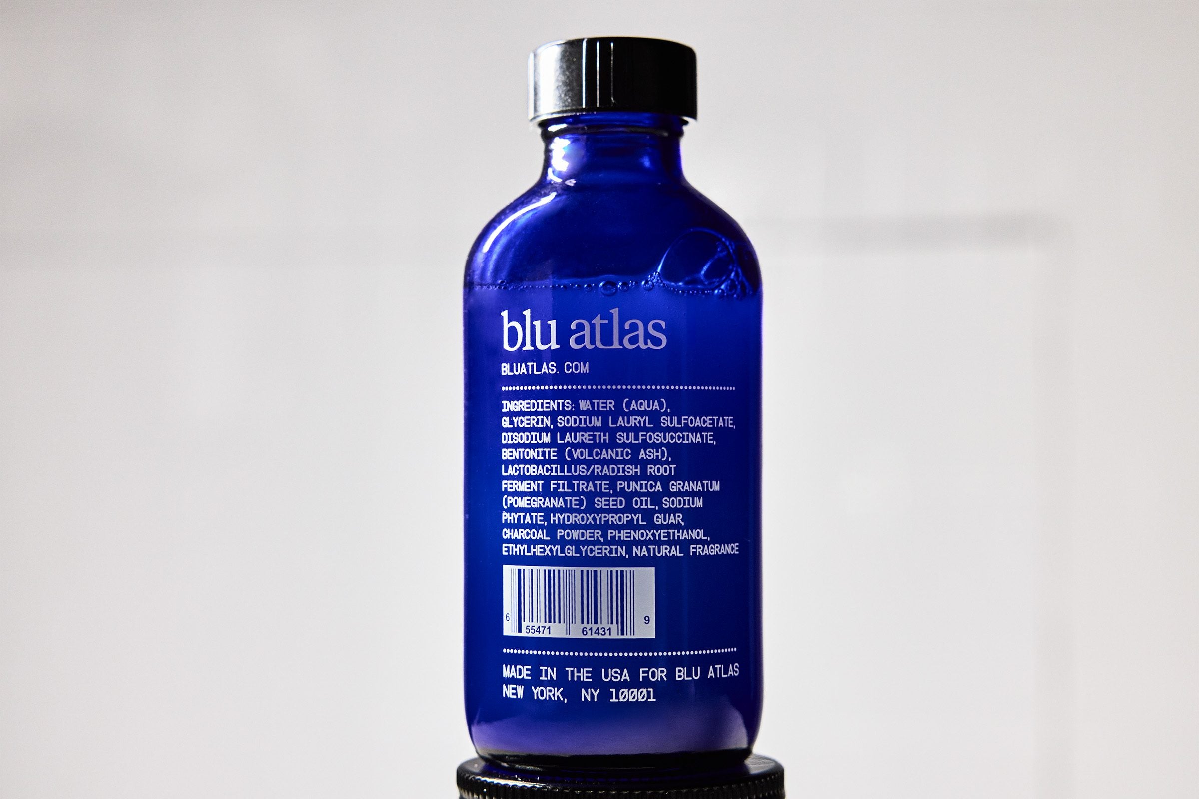 Close up of Blu Atlas Volcanic Ash Face Cleanser on a white background