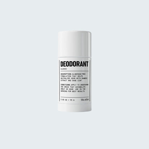 A white cylindrical stick of Blu Atlas Natural Deodorant labeled “Natural Deodorant” sits on a plain light background, highlighting its aluminum-free formula with arrowroot.