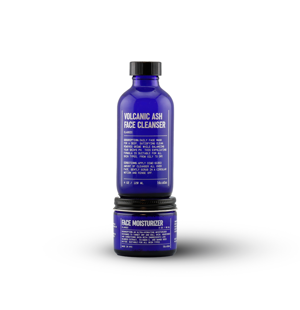 The Blu Atlas Clean and Hydrate Duo features two blue bottles—a Volcanic Ash Face Cleanser and a Face Moisturizer—displayed against a white background to cleanse and hydrate your skin for a balanced, refreshed look.