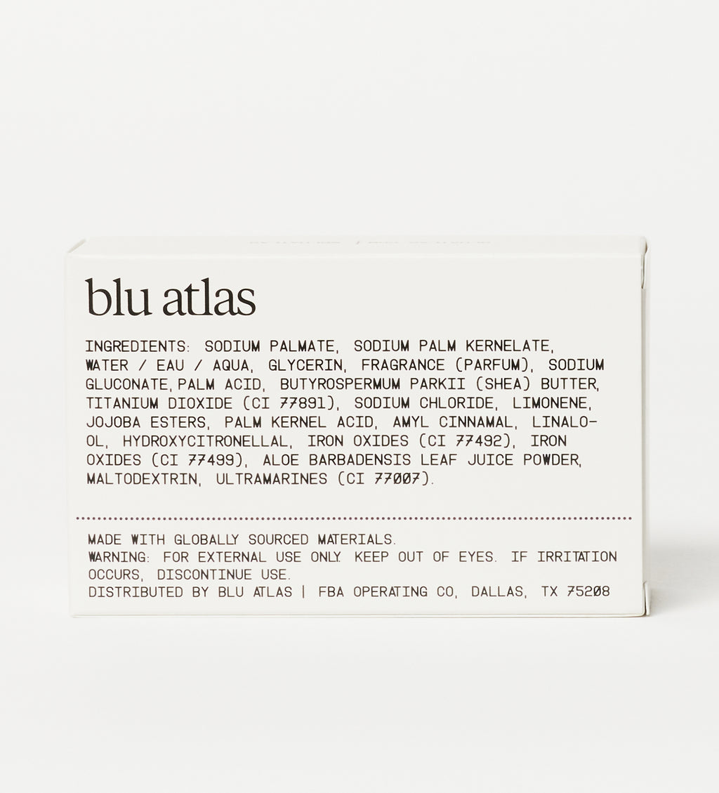 The back of a Blu Atlas Natural Exfoliating Bar Soap box showcases the ingredients list, highlighting nourishing Shea Butter and gentle Jojoba Beads for a smooth cleanse, along with essential warning information.