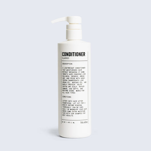 White pump bottle labeled Blu Atlas Natural Conditioner, featuring a detailed product description and instructions in black text on the front against a light gray background. This daily conditioner offers effortless, everyday hair care.