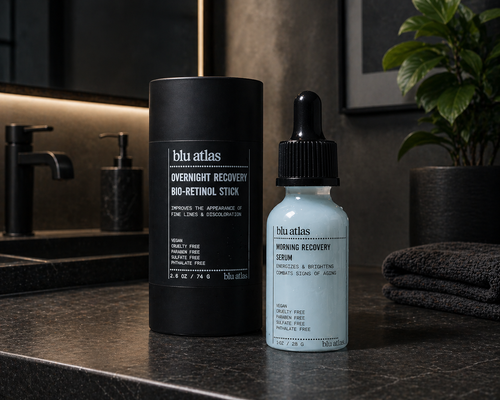 The Blu Atlas Morning/Night Bundle, with an Overnight Recovery Bio-Retinol Stick and Morning Recovery Serum, sits on a bathroom counter—ideal for hydrating and firming skin as part of your daily routine.
