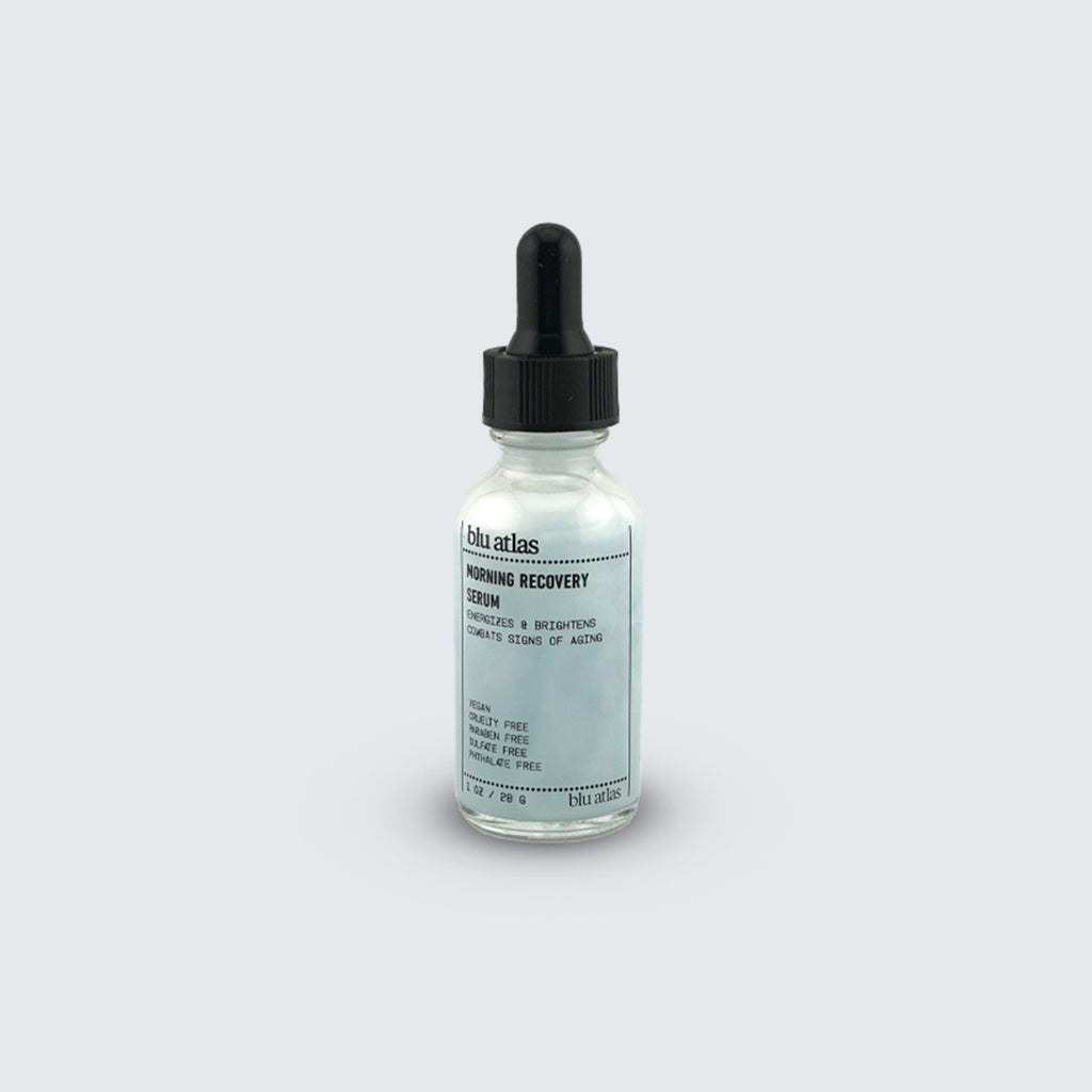 A clear glass dropper bottle labeled Blu Atlas Morning Recovery Serum with a black cap, highlighted by Copper Tripeptide-1, sits against a plain light gray background.