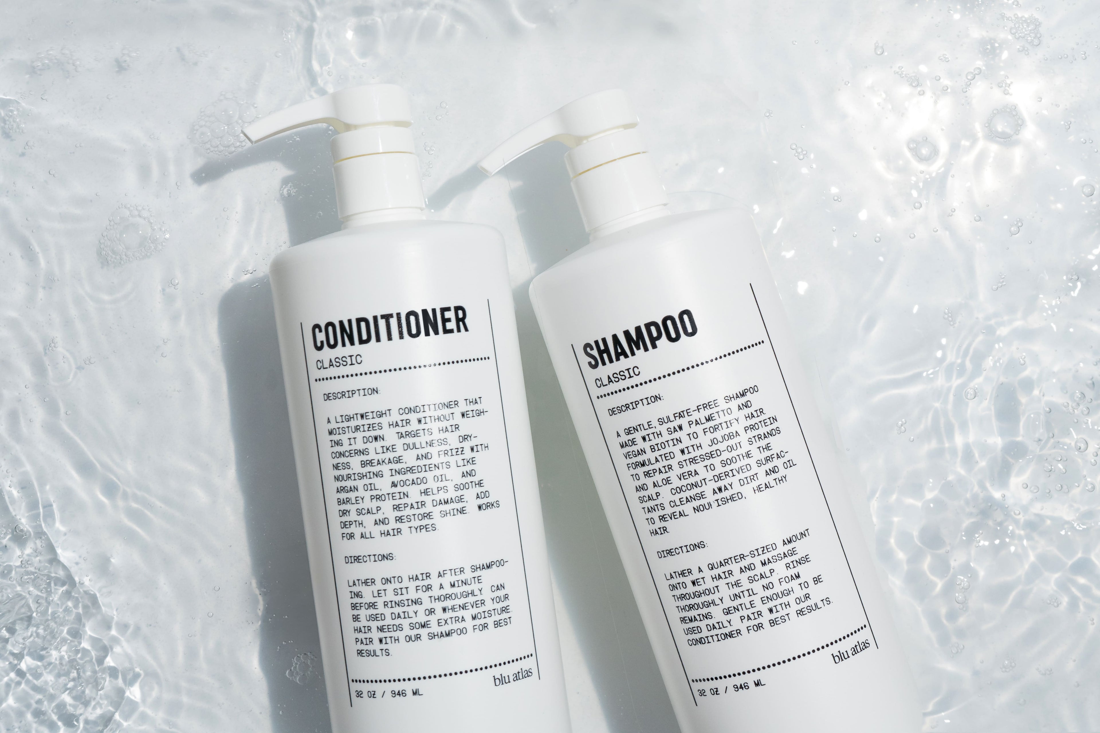 Two bottles of Blu Atlas shampoo and conditioner on a textured white background