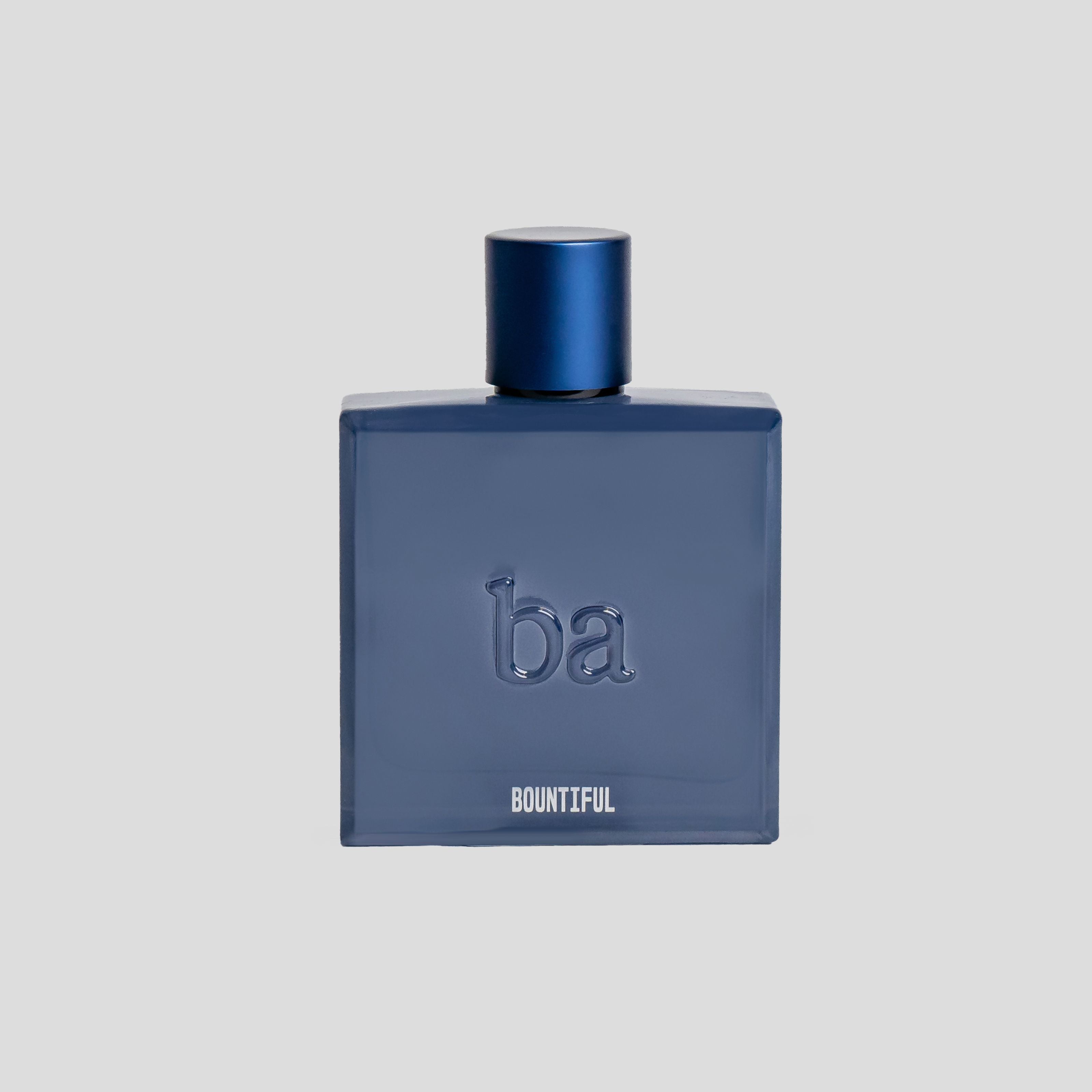A dark blue perfume bottle labeled ba BOUNTIFUL