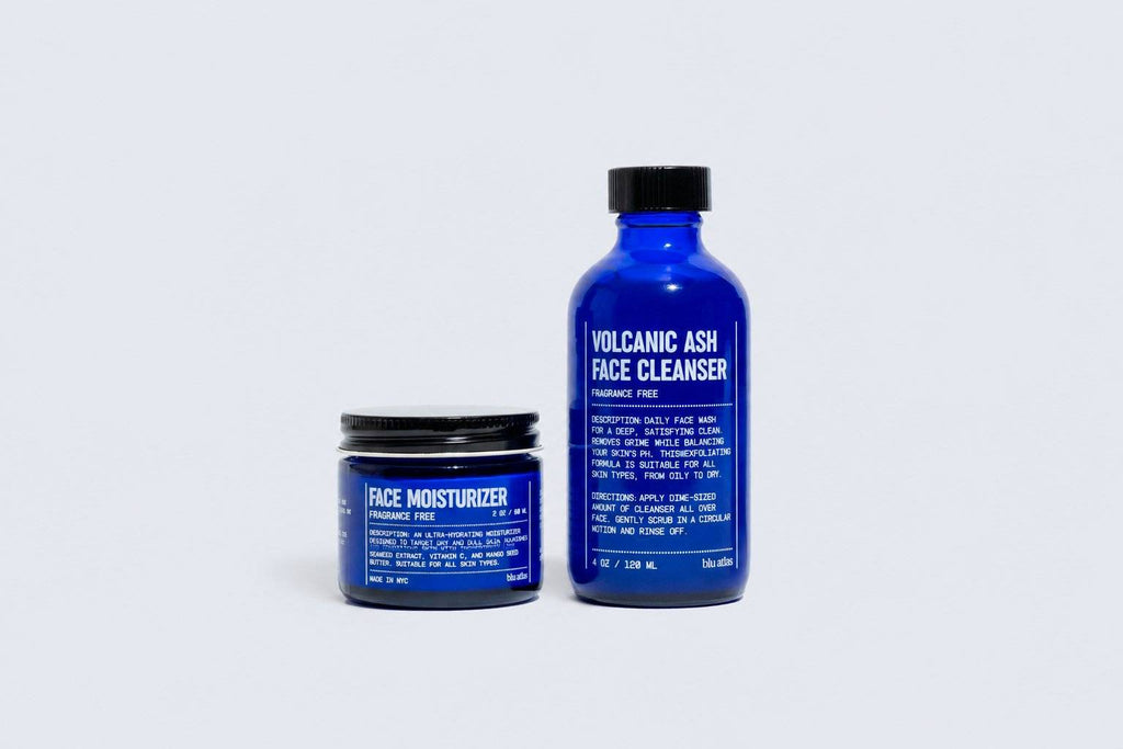 Blue containers feature Blu Atlas' Face Moisturizer jar and Volcanic Ash Face Cleanser bottle (FOR LANDING PAGE ONLY), both with bold white text on a plain background—ideal for your daily skincare routine.
