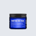 A blue jar labeled Blu Atlas Purifying Face Mask with white text, featuring product details and a black screw-on lid, is centered against a light gray background. This rejuvenating formula combines the benefits of goji berry and kaolin clay for a clearer, more refined complexion.