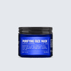 A blue jar labeled Blu Atlas Purifying Face Mask with white text, featuring product details and a black screw-on lid, is centered against a light gray background. This rejuvenating formula combines the benefits of goji berry and kaolin clay for a clearer, more refined complexion.