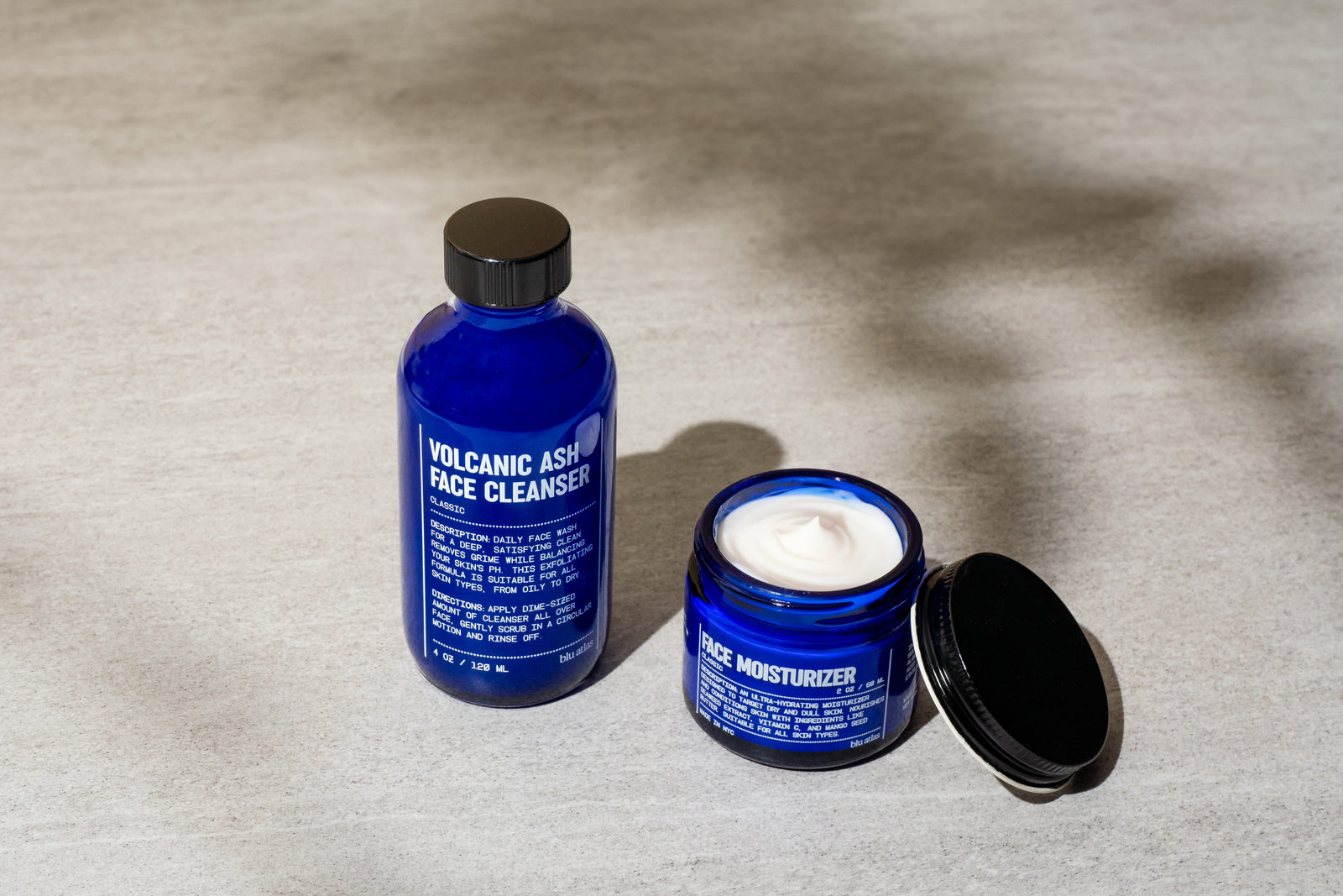Two Blu Atlas Face Essentials - blue skincare products on a textured surface