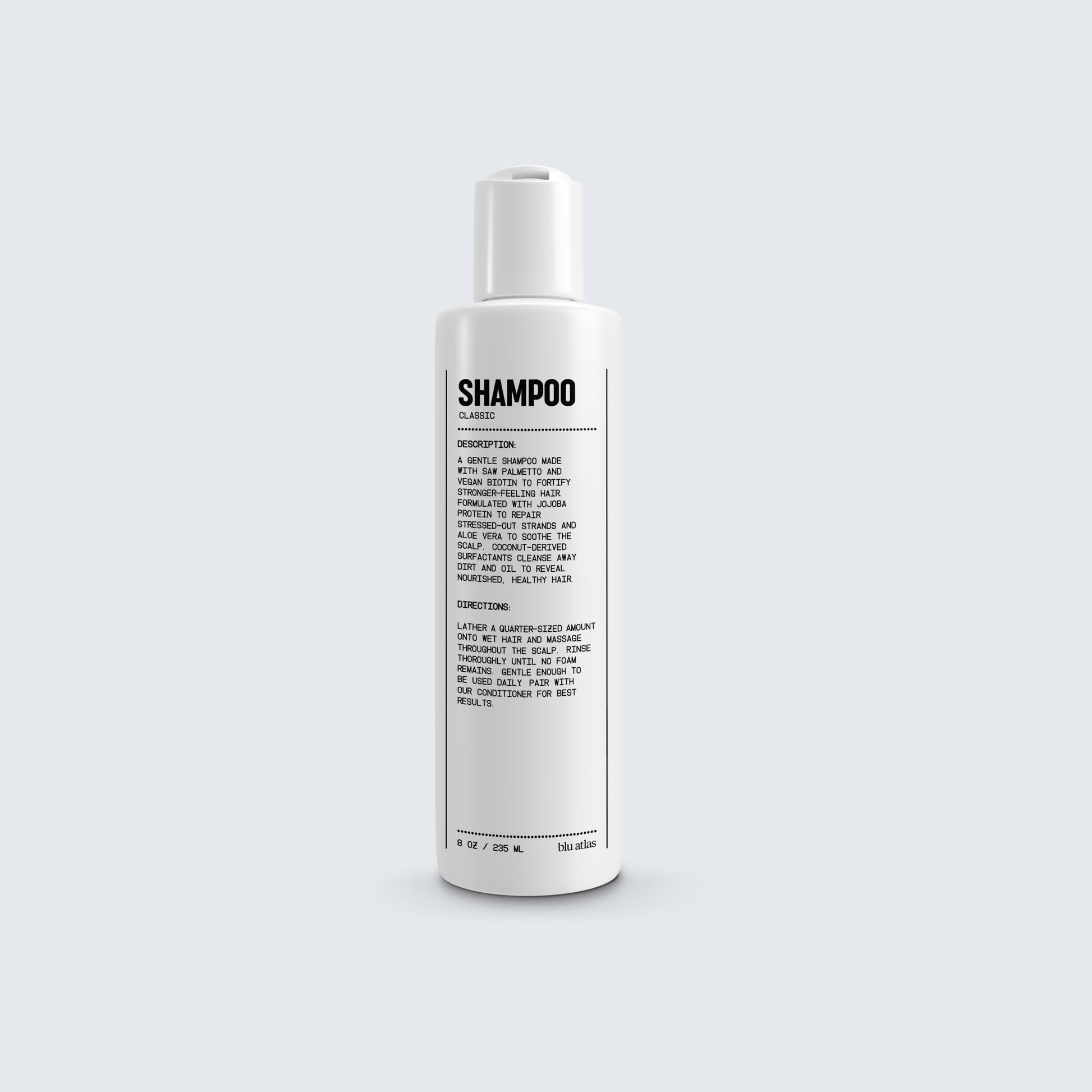 A shampoo bottle labeled with details in black text showcases ingredients such as jojoba protein and vegan biotin, along with usage instructions, comes from Blu Atlas's Natural Shampoo for All Hair Types line.