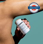 A person applies Blu Atlas Add 48-Hour Natural Deodorant with aluminum-free Sage Leaf and Bamboo Extract to their underarm, featuring an AskMen Grooming Awards 2022 logo in the top right corner.