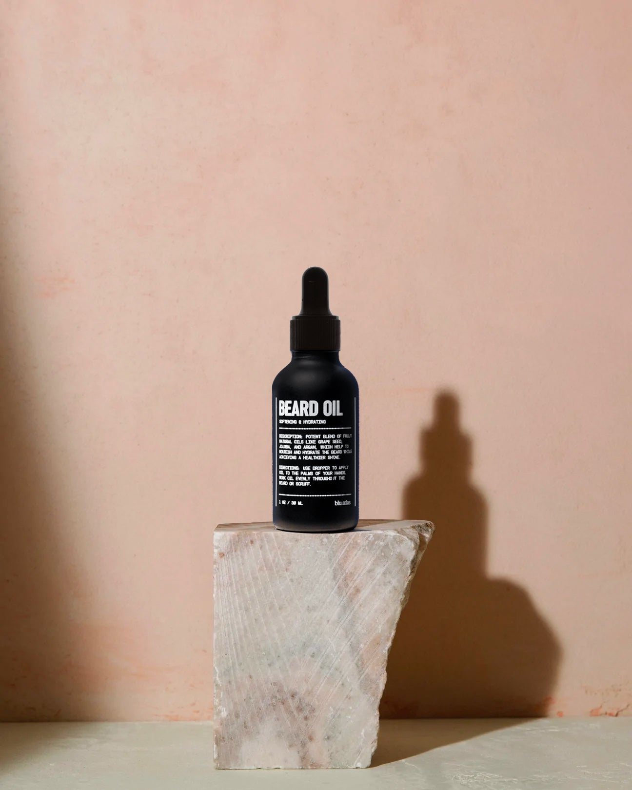 Blu Atlas beard oil in black bottle with dropper