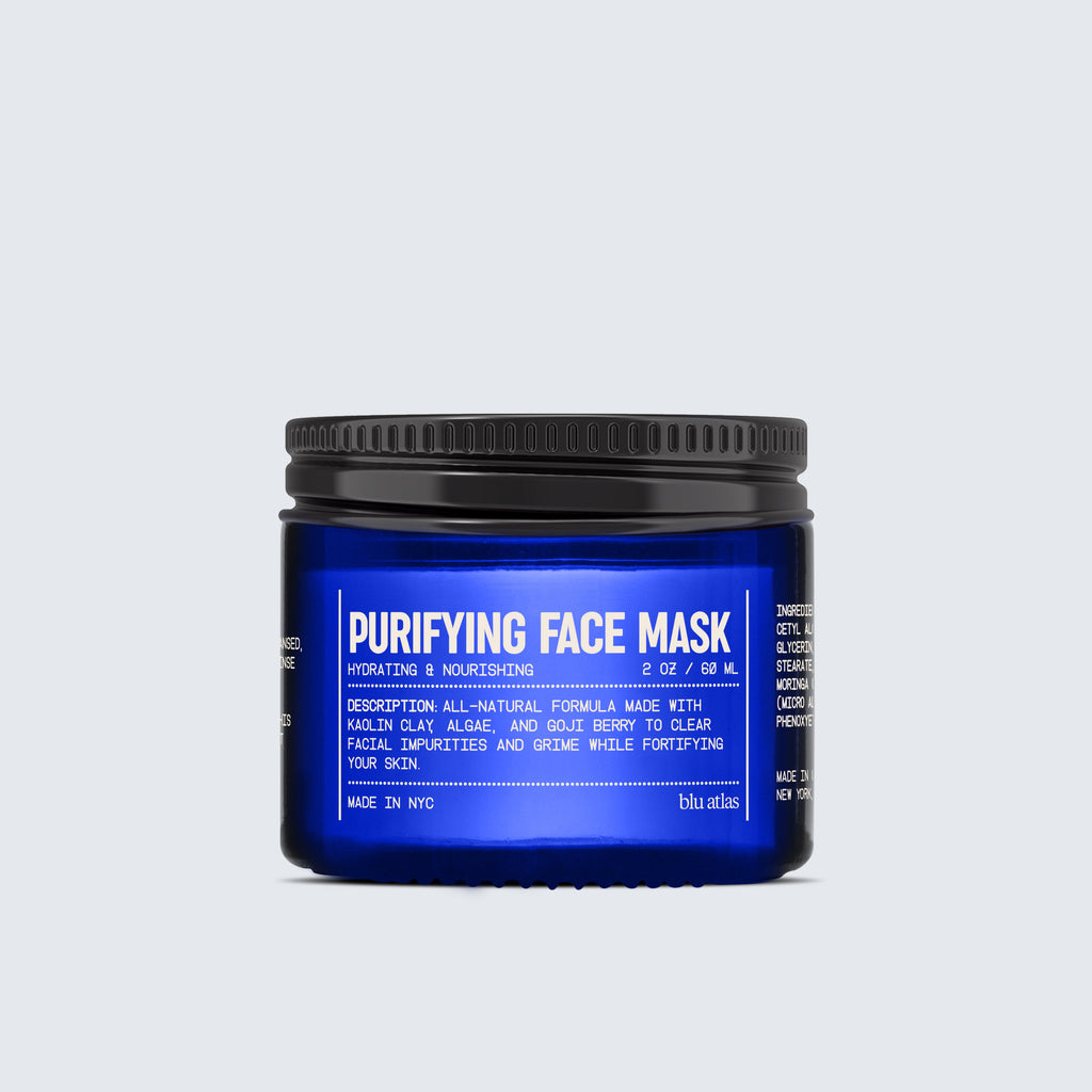 A jar from the Advanced Skincare Set by Blu Atlas, featuring a blue design, includes detailed text about its ingredients and benefits for hydrating and nourishing skin. Made in NYC.