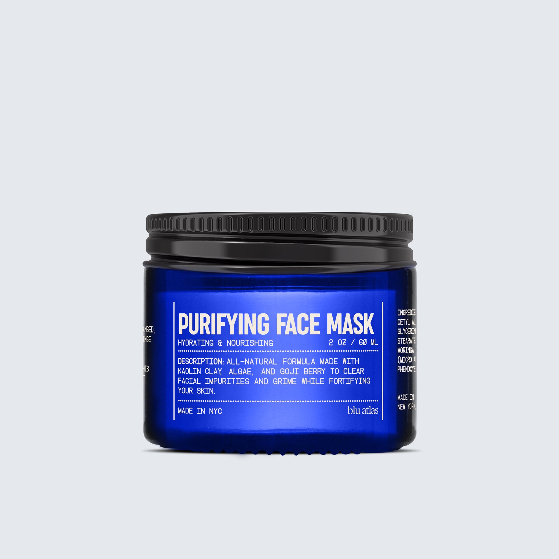 A jar from the Advanced Skincare Set by Blu Atlas, featuring a blue design, includes detailed text about its ingredients and benefits for hydrating and nourishing skin. Made in NYC.
