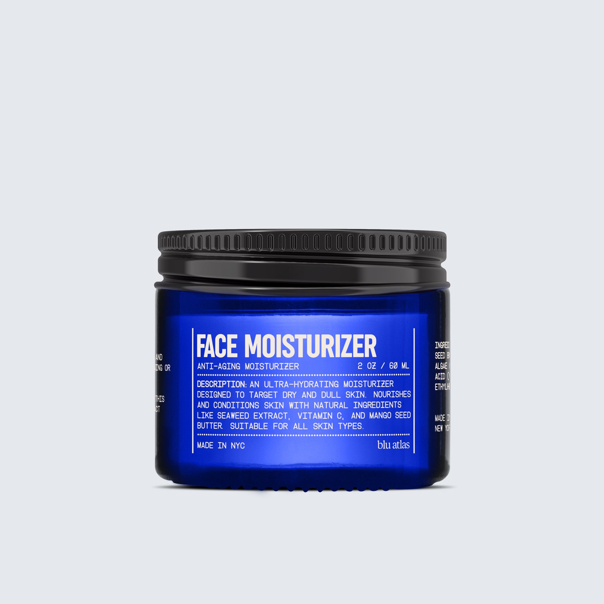 A blue jar labeled as part of the Blu Atlas Advanced Skincare Set, specifically the Face Moisturizer, offers a rejuvenating solution for dry and dull skin. This anti-aging product includes powerful ingredients such as seaweed extract and mango seed butter. For radiant results, pair it with our Vitamin C Serum. Made in NYC.