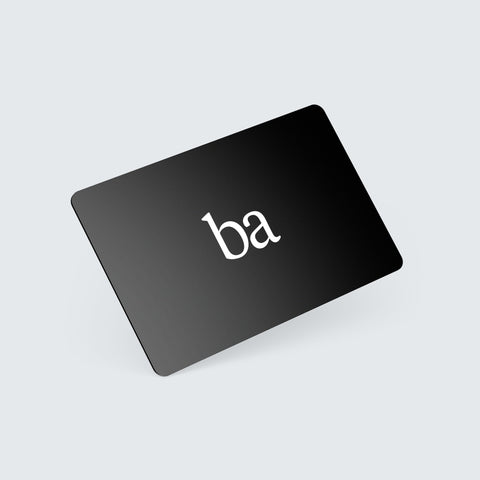 A black card with lowercase letters ba printed in white, positioned diagonally on a light gray background.