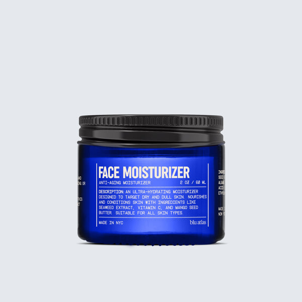 A jar of Blu Atlas Hydrating Face Moisturizer for All Skin Types, in dark blue, showcases a white label with product details and includes seaweed extract for anti-aging benefits.